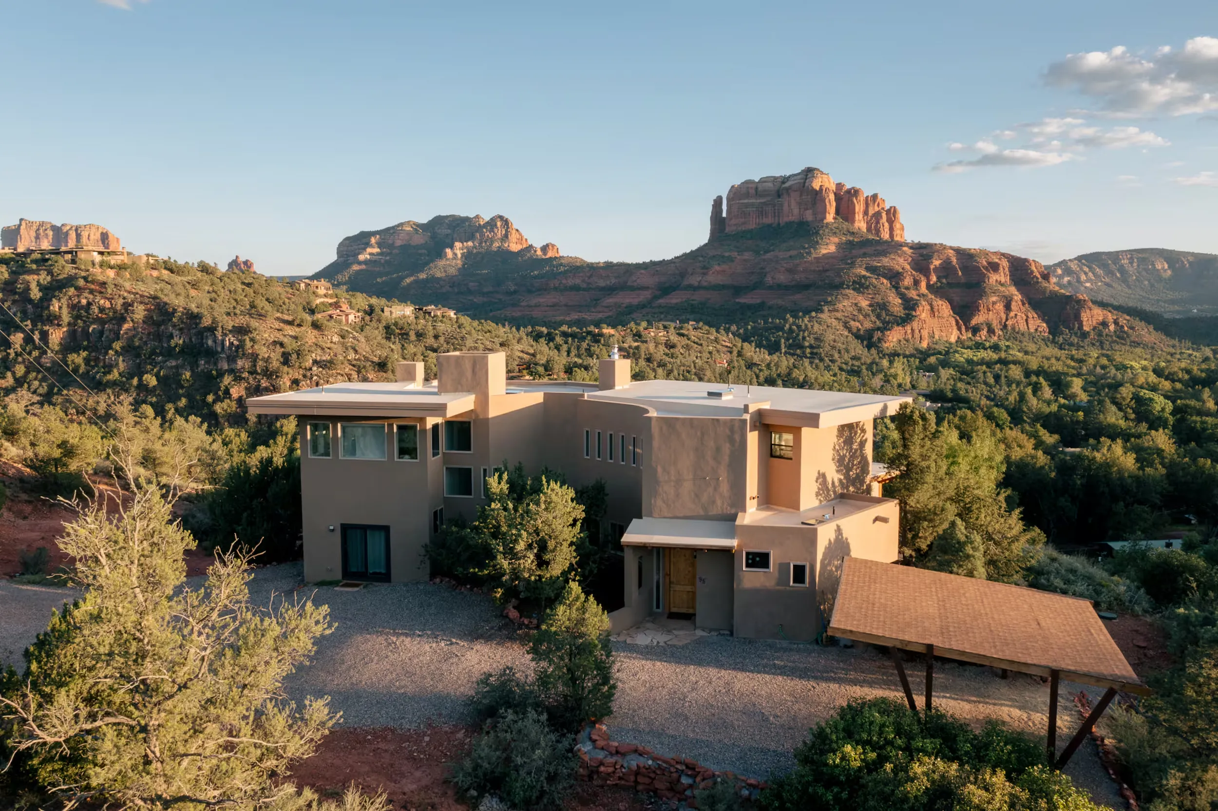 The Sky Castle, the Sedona retreat house, with Cathedral Rock rising behind it in evening light